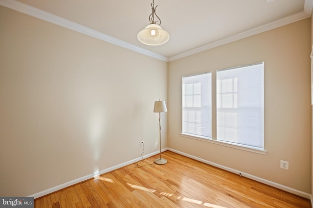 spare room featuring crown molding and wood-type flooring