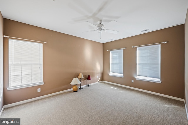 spare room featuring ceiling fan and carpet flooring