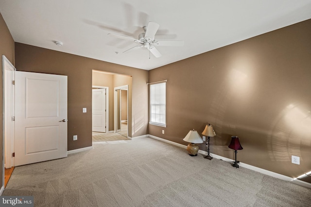 unfurnished bedroom featuring light colored carpet and ceiling fan