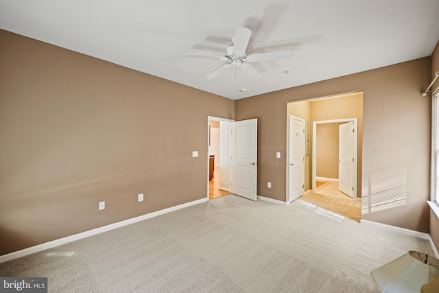 unfurnished bedroom with light carpet and ceiling fan