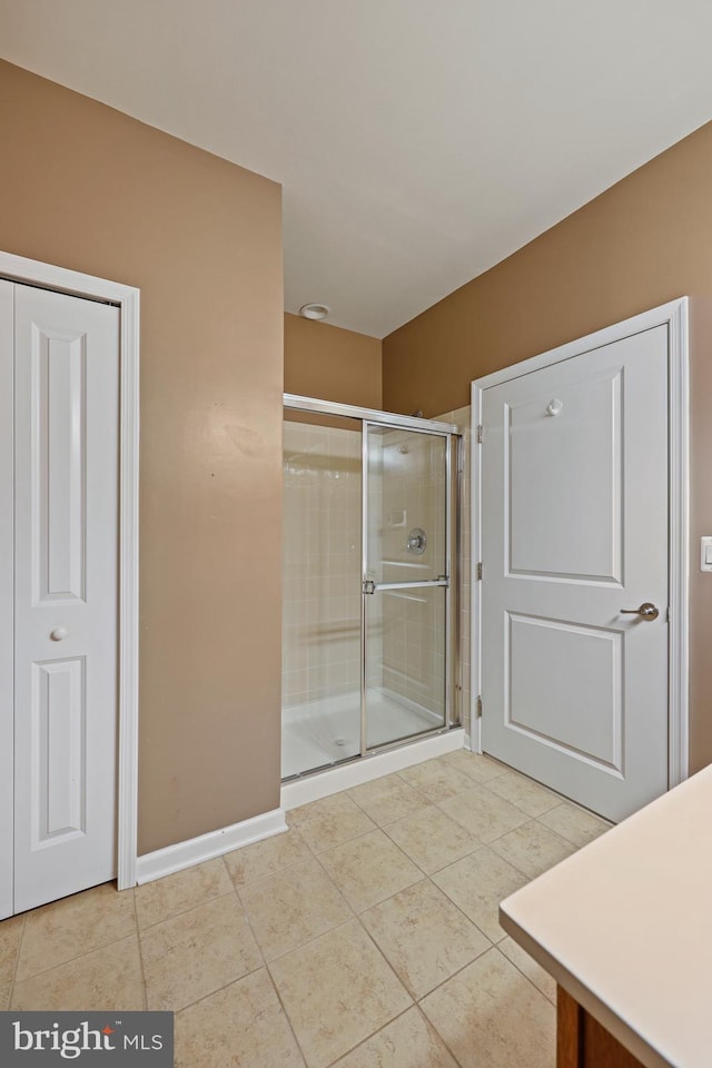 bathroom with tile patterned floors and walk in shower