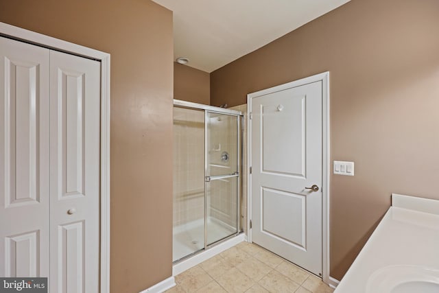 bathroom with vanity, tile patterned floors, and a shower with shower door