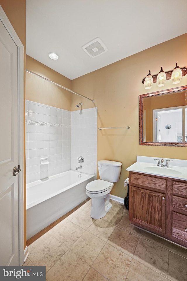 full bathroom featuring tiled shower / bath combo, vanity, and toilet