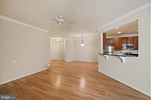 unfurnished living room featuring ornamental molding, ceiling fan, and light wood-type flooring