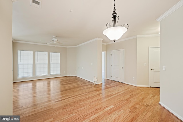 empty room featuring crown molding, ceiling fan, and light wood-type flooring