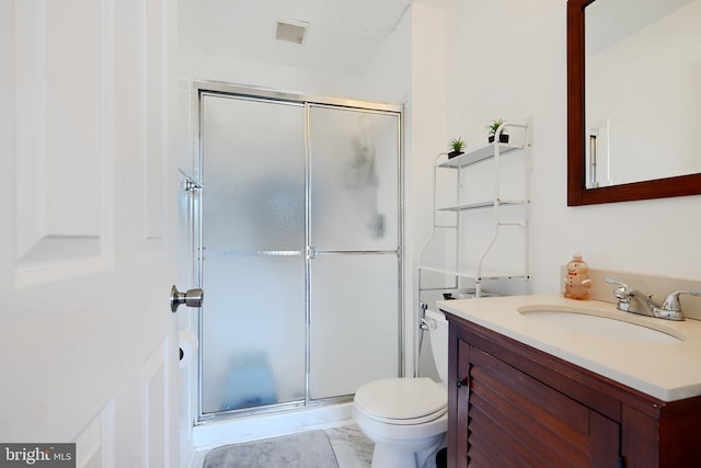 bathroom featuring vanity, toilet, and walk in shower