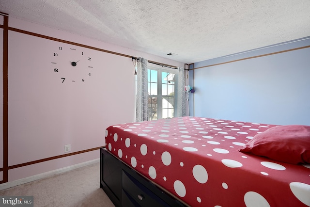 carpeted bedroom featuring a textured ceiling