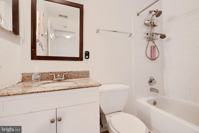 full bathroom with vanity, toilet, and tiled shower / bath