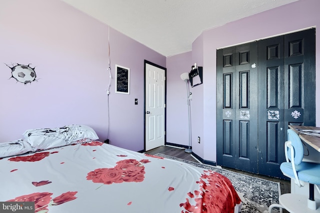 bedroom with dark wood-type flooring