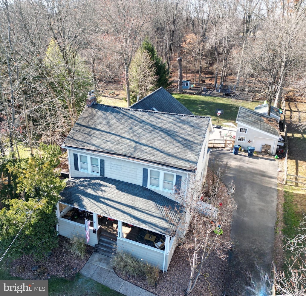 view of front of house with an outbuilding, a garage, and a front lawn