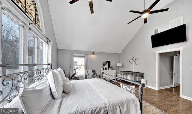 bedroom featuring high vaulted ceiling, visible vents, baseboards, and wood finished floors