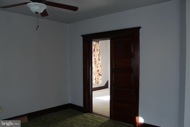 carpeted spare room featuring ceiling fan