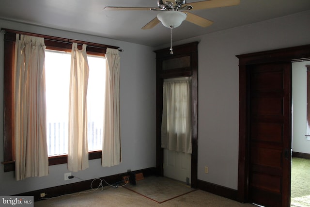 empty room featuring carpet floors and ceiling fan