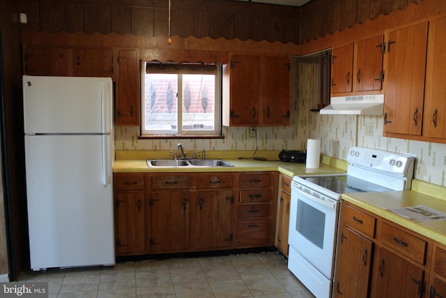 kitchen featuring white appliances and sink