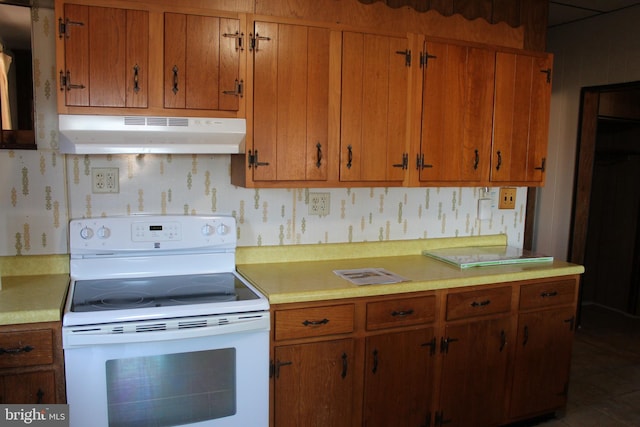 kitchen featuring electric range and dark tile patterned floors