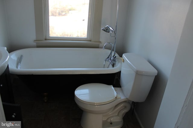 bathroom with tile patterned flooring, toilet, and a bath