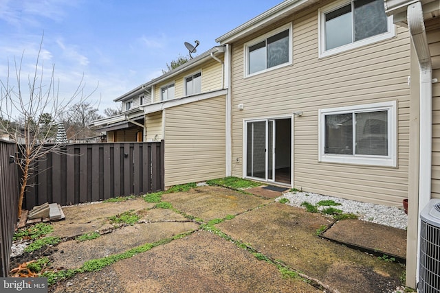 rear view of property featuring central air condition unit and a patio