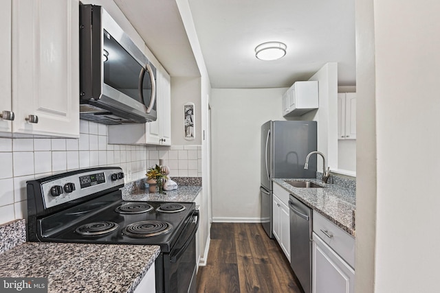 kitchen featuring tasteful backsplash, stainless steel appliances, dark wood-type flooring, sink, and white cabinetry