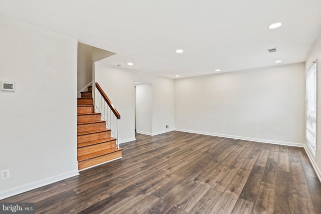 unfurnished living room with dark wood-type flooring