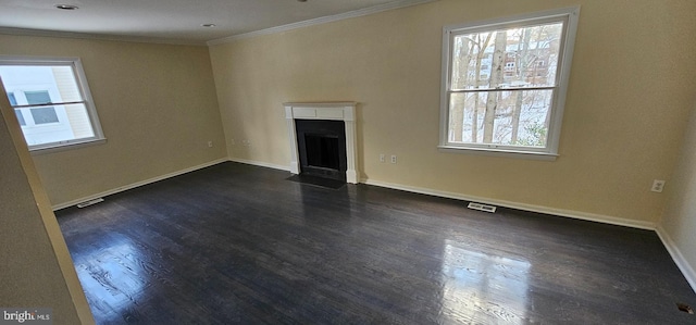 unfurnished living room featuring crown molding, plenty of natural light, and dark wood-type flooring