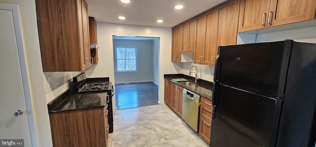 kitchen with sink, dark stone countertops, and black appliances