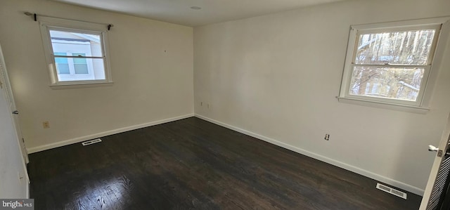 unfurnished room featuring dark wood-type flooring