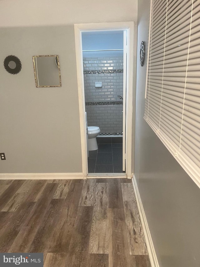 hallway with dark wood-type flooring