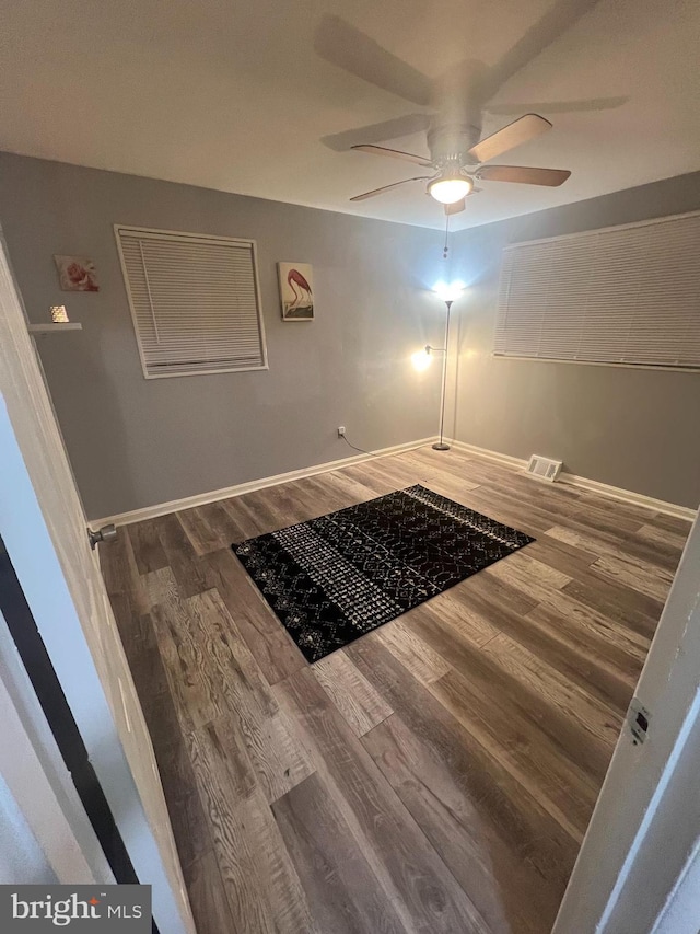 hallway with hardwood / wood-style floors