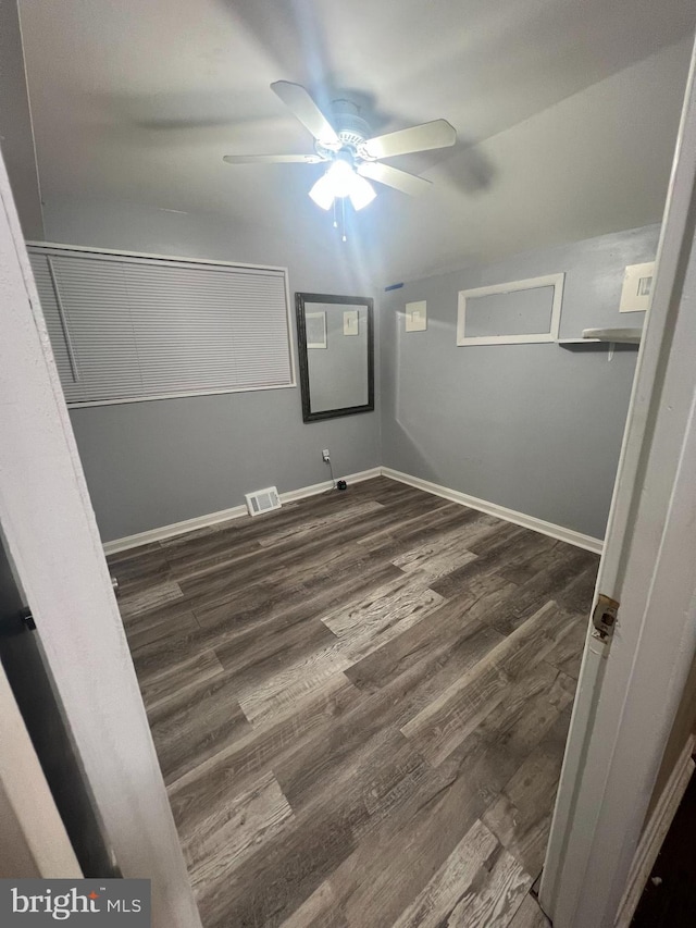 unfurnished bedroom with ceiling fan, a closet, and dark hardwood / wood-style floors