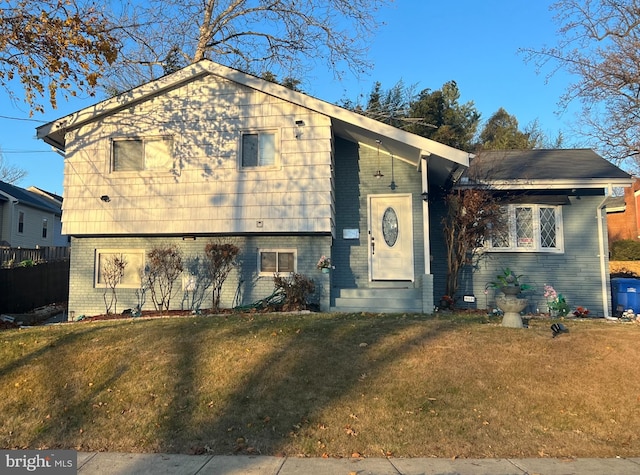 tri-level home with a front lawn