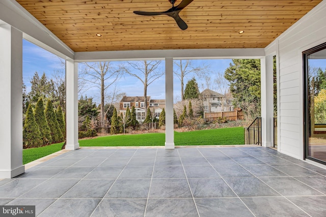 unfurnished sunroom featuring ceiling fan and wood ceiling