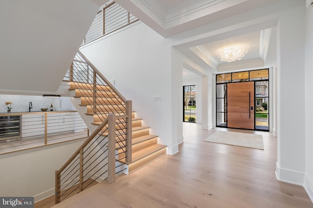 foyer entrance featuring light hardwood / wood-style flooring and a notable chandelier