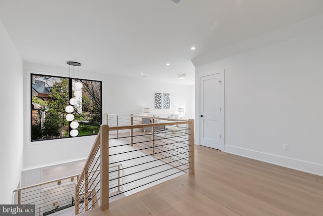 hallway with light hardwood / wood-style floors