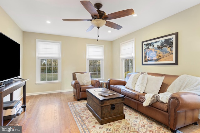 living room with ceiling fan and light hardwood / wood-style flooring