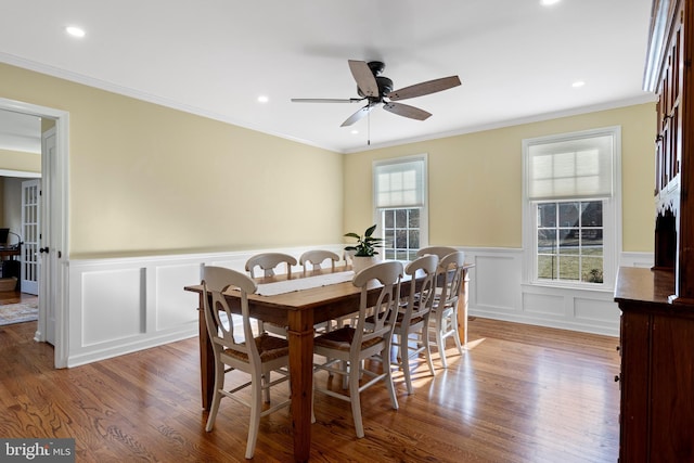 dining room with ceiling fan, hardwood / wood-style floors, and crown molding