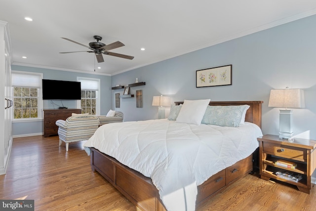 bedroom featuring light wood-type flooring, ceiling fan, and ornamental molding