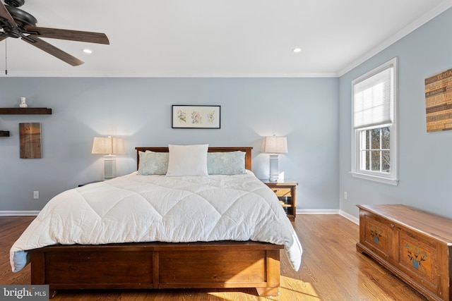 bedroom featuring ceiling fan, light hardwood / wood-style flooring, and crown molding