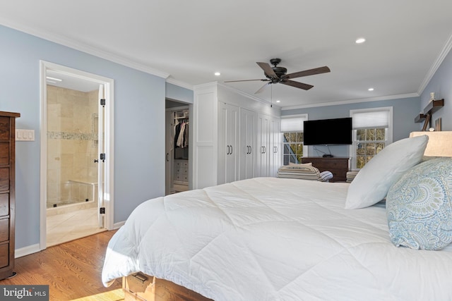 bedroom featuring ceiling fan, ensuite bathroom, crown molding, and light hardwood / wood-style flooring