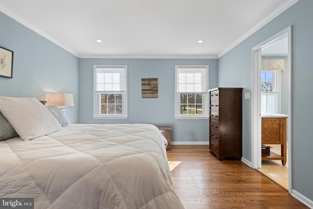 bedroom with multiple windows, light hardwood / wood-style flooring, and ornamental molding