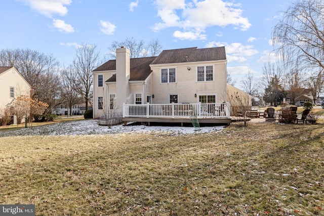 back of house featuring a wooden deck and a yard