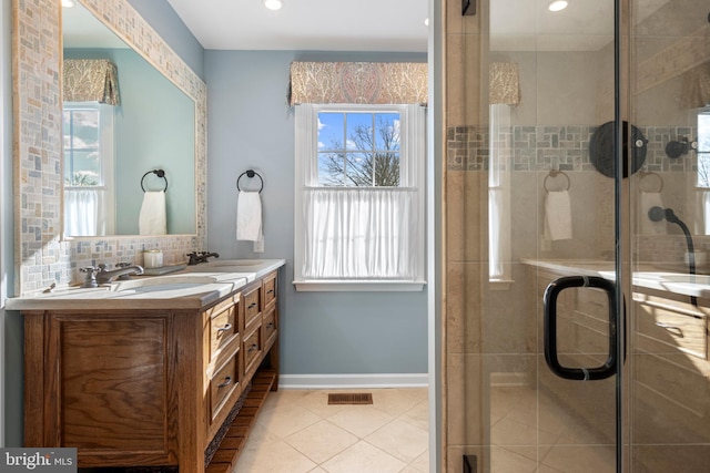 bathroom with a shower with shower door, vanity, backsplash, and tile patterned flooring