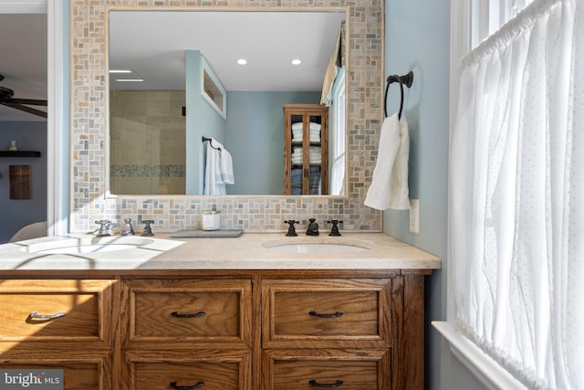 bathroom featuring decorative backsplash, vanity, and ceiling fan