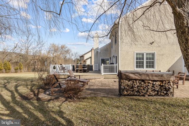 exterior space with a wooden deck and a patio