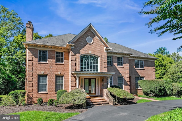 colonial inspired home with french doors