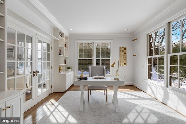 office area with french doors, ornamental molding, and light hardwood / wood-style floors