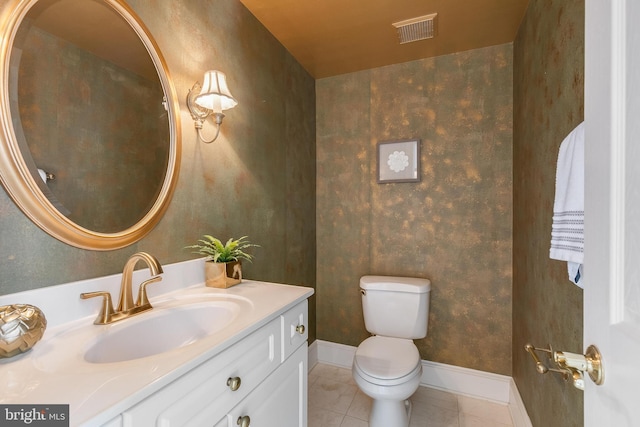 bathroom with toilet, tile patterned flooring, and vanity