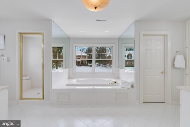 bathroom with independent shower and bath and tile patterned flooring