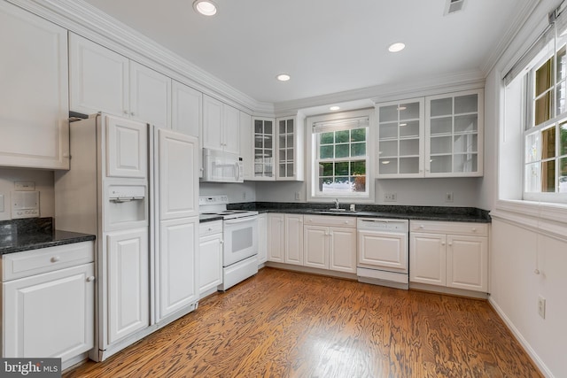 kitchen featuring sink, white appliances, white cabinetry, and ornamental molding