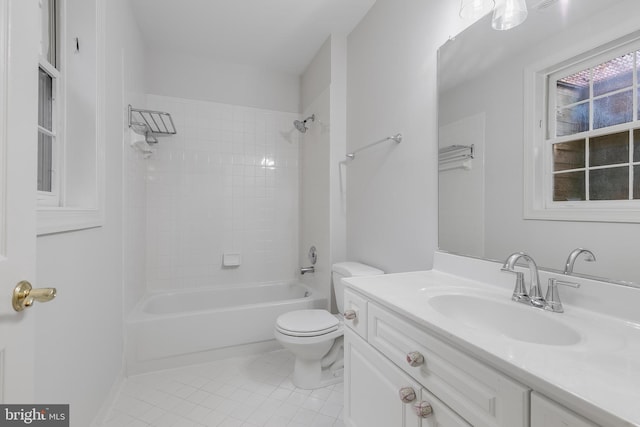 full bathroom featuring toilet, tiled shower / bath combo, tile patterned flooring, and vanity