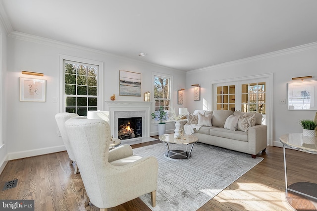 living room with french doors, hardwood / wood-style floors, and crown molding